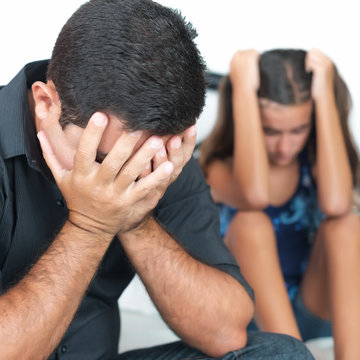 Sad father after arguing with her teen daughter