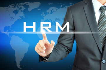 Businessman hand touching HRM (Human Resources Management) sign