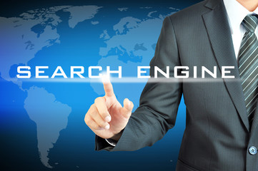 Businessman hand touching SEARCH ENGINE sign on virtual screen