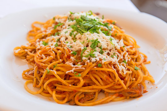  Vegetarian spaghetti with cheese on a white plate