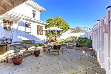 Backyard patio area with small garden