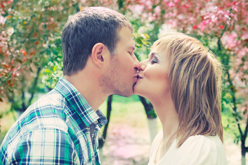 Young couple kissing in park