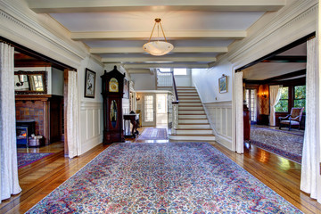 Luxury house. Hallway with rug and staircase