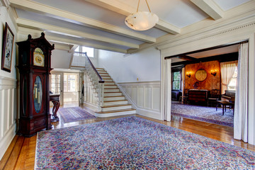 Luxury house. Hallway with rug and staircase
