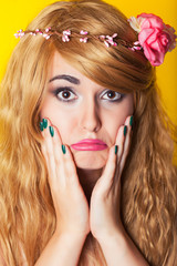 Naklejka premium sad beautiful young woman wearing wreath against yellow backgrou