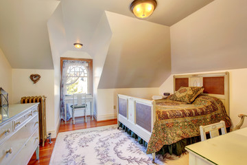 Cozy small bedroom with vaulted ceiling