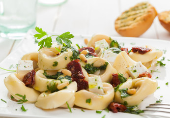 Tortellini with feta, basil, pine nuts and tomato