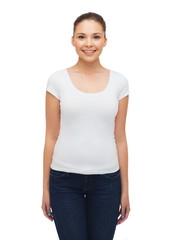 Fototapeta premium smiling young woman in blank white t-shirt