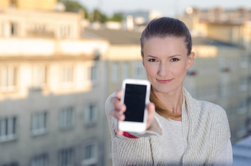 Young woman showing display of mobile cell phone