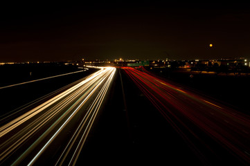 Fototapeta na wymiar Light trails on a highway at night