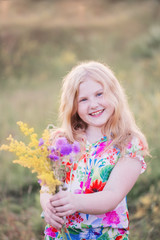 happy gir with flowersl on meadow