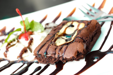 Cream cheese brownies on a white plate