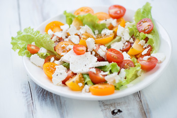 Salad with various types of tomatoes and feta cheese