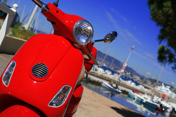 Red scooter against the sea and yachts, France © Zarya Maxim