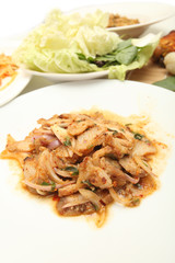 Thai cuisine spicy pork salad , Moo Nam Tok isolated white backg
