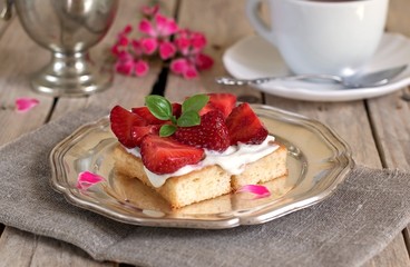 Tasty cake with cream and strawberries