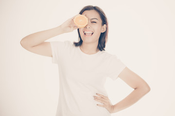 Young woman holding fresh oranges. Healthy eating. Isolated over