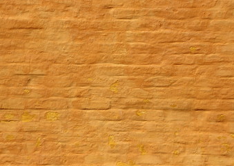 Old ochre yellow painted brick wall background