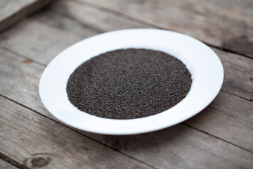 Dry sweet basil seed on wood table