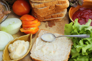 making tuna sandwich with fresh vegetables