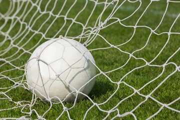 Naklejka premium Football at the back of the net