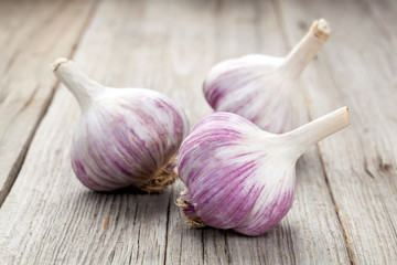 Organic garlic whole and cloves on the wooden background