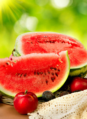Juicy ripe organic watermelon closeup over nature background