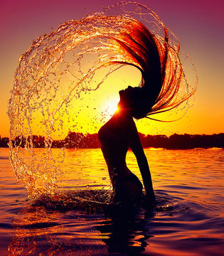 Beauty model girl splashing water with her hair