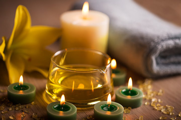 SPA still life with herbal oil  towel over green background