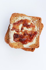 Butter and strawberry jam on toast