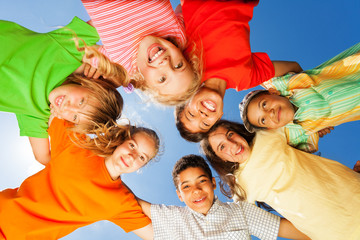Happy kids close in circle on sky background
