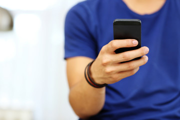 Closeup portrait of a male hands holding smartphone