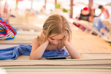 Cute little girl learning with tablet pc