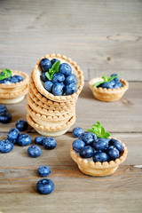 Fototapeta na wymiar Tarts with blueberries on a wooden background