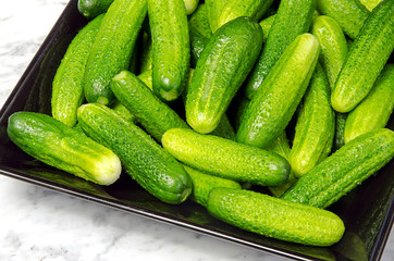 Gherkins on a black plate