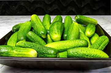 Gherkins on a black plate