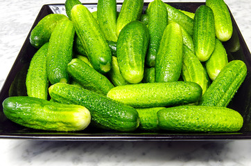 Gherkins on a black plate