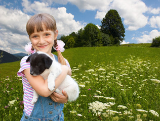 little girl playing with small  puppiy