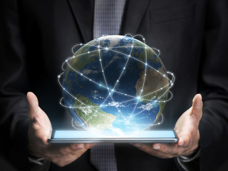 Businessman holding a tablet with planet Earth