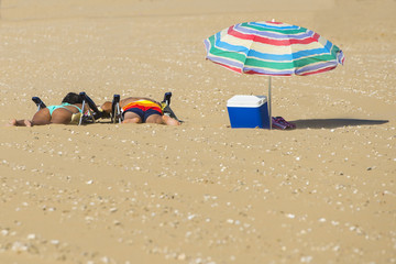 couple lying in the sun on the beach