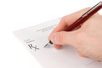 Doctor filling in empty medical prescription
