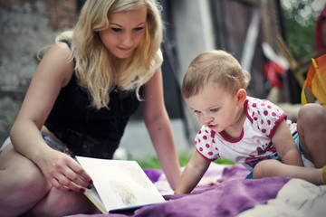 Mother with daughter reading a book