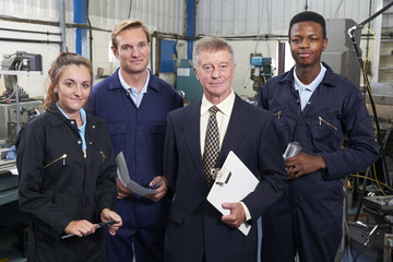 Portrait Of Manager And Staff In Engineering Factory