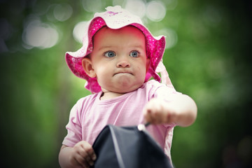 Small girl in the forest opening bag