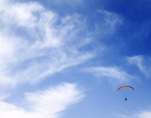 Silhouette of skydiver at sky