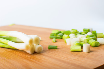 Spring green onion on wooden board