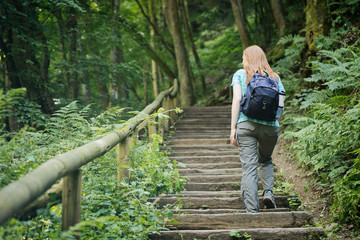 Woman Climbing Stairs in a Forest