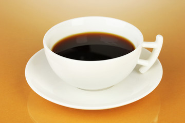 A cup of strong coffee on beige background