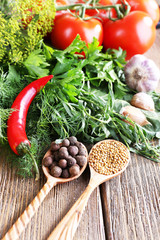 Fresh vegetables with herbs and spices on table, close-up
