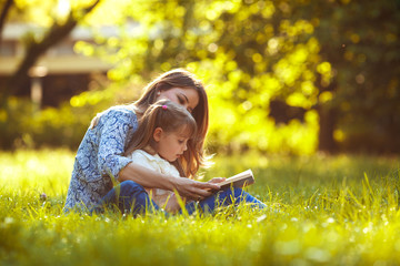 Mother and daughter relaxing in park.